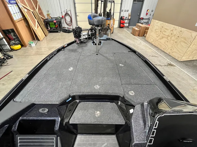 Slide: The Image of 2025 Ranger Z520 boat storage compartments open in a workshop setting. - 14