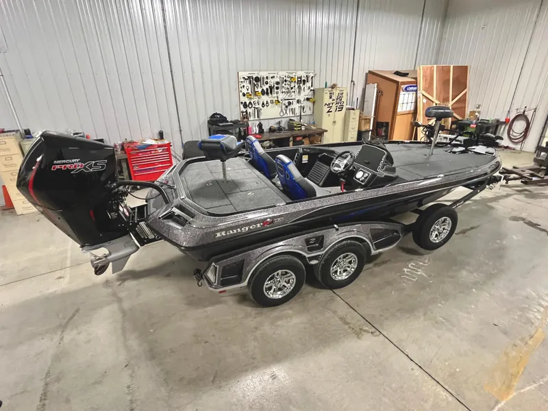 Slide: The Image of 2025 Ranger Z520 boat in a garage, featuring a powerful outboard motor. - 3