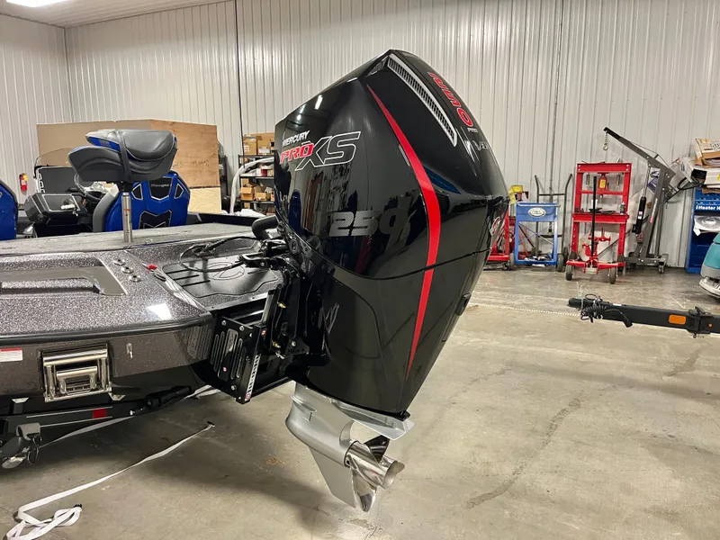 Slide: The Image of 2025 Ranger Z520 boat in a garage, featuring a powerful outboard motor. - 5