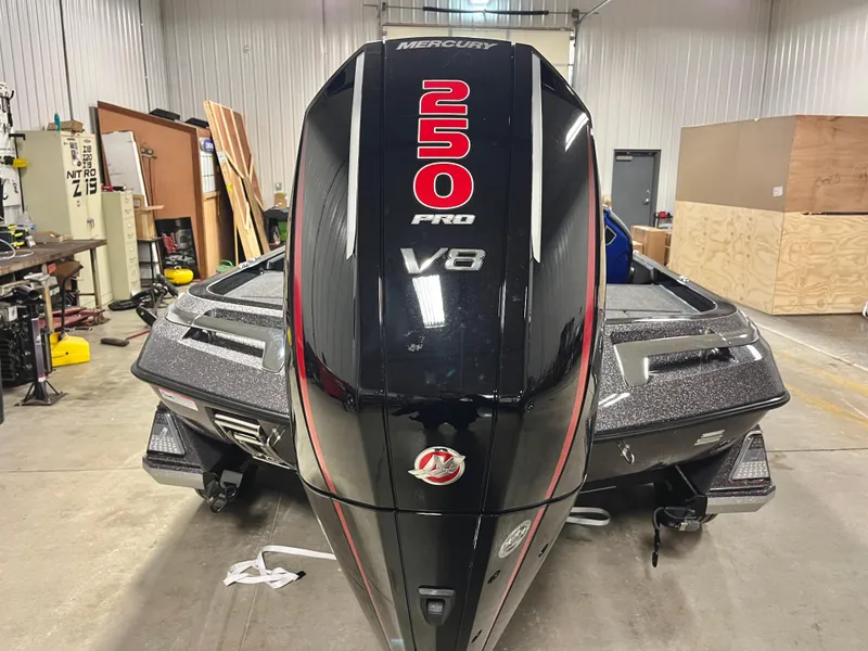 Slide: The Image of 2025 Ranger Z520 boat with Mercury Pro XS engine in a garage setting. - 6