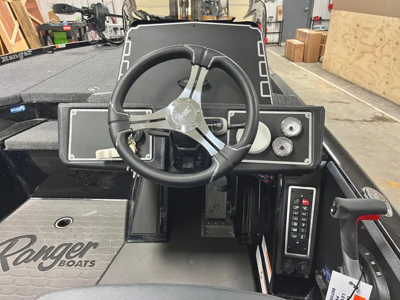 Slide: The Image of 2025 Ranger Z520 boat with Mercury Pro XS outboard motor in a workshop setting. - 8