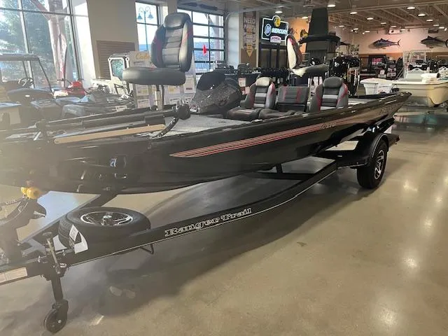 Slide: The Image of 2025 Ranger RT178 boat on display in showroom, featuring sleek design and modern seating. - 0