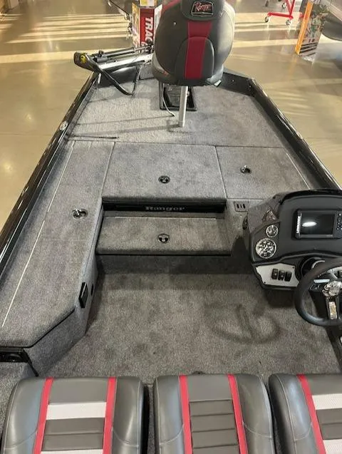 Slide: The Image of 2025 Ranger RT178 boat interior with gray and red seating, steering console, and storage compartments. - 3