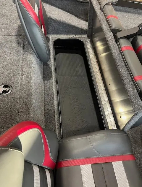 Slide: The Image of 2025 Ranger RT178 boat interior with storage compartment and red-accented seats. - 5