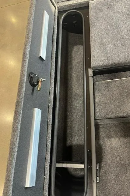 Slide: The Image of 2025 Ranger RT178 boat storage compartment with carpeted interior and lock mechanism. - 8