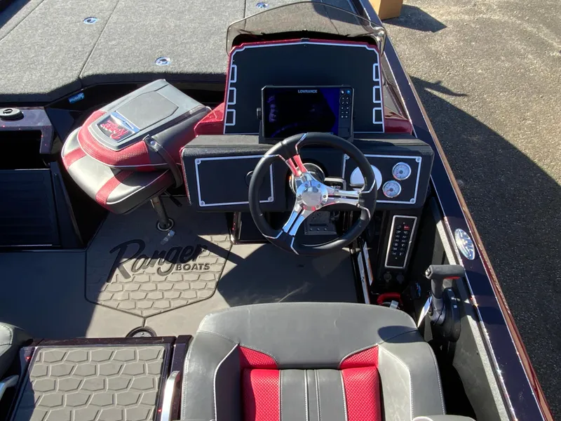 Slide: The Image of 2025 Ranger Z520 boat cockpit with steering wheel, dashboard, and seating. - 11