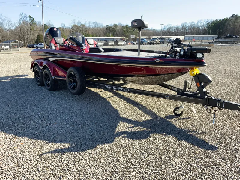 Slide: The Image of 2025 Ranger Z520 boat on trailer in gravel lot, sunny day. - 15