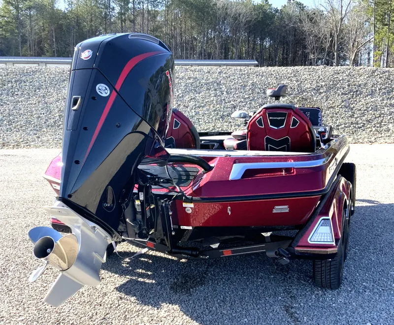 Slide: The Image of 2025 Ranger Z520 boat with powerful outboard motor, red and black design, parked outdoors. - 18