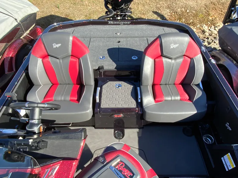 Slide: The Image of 2025 Ranger Z520 boat interior with red and gray seats, steering wheel, and storage. - 8