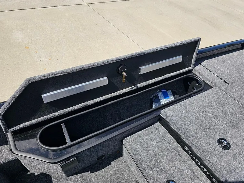 Slide: The Image of 2025 Ranger RT178 boat storage compartment with open lid and key lock. - 19