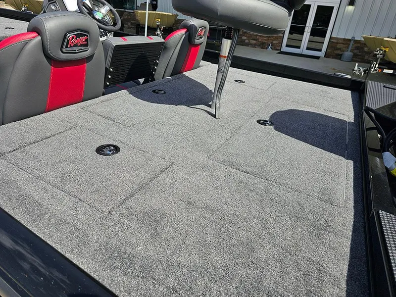 Slide: The Image of 2025 Ranger RT178 boat interior with gray carpet and red-accented seats. - 9