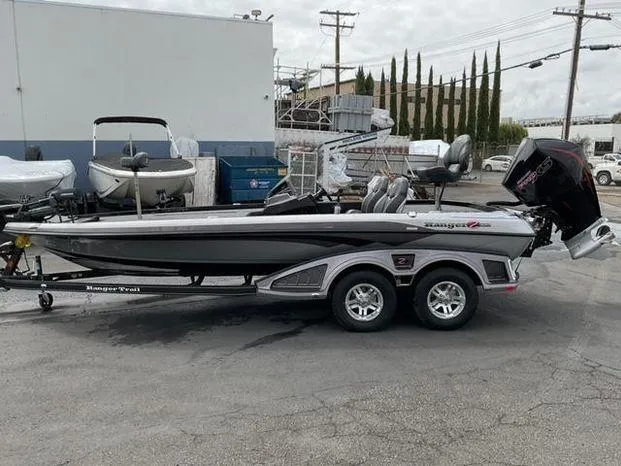 The Image of 2025 Ranger Z520 boat on trailer in industrial area. - 0