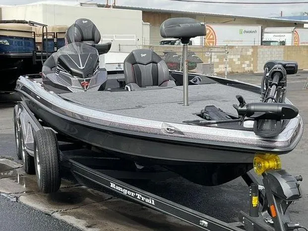 Slide: The Image of 2025 Ranger Z520 fishing boat on trailer, parked outdoors. - 2