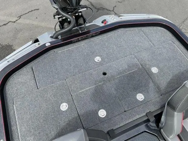 Slide: The Image of 2025 Ranger Z520 boat deck with carpeted surface and storage compartments. - 6