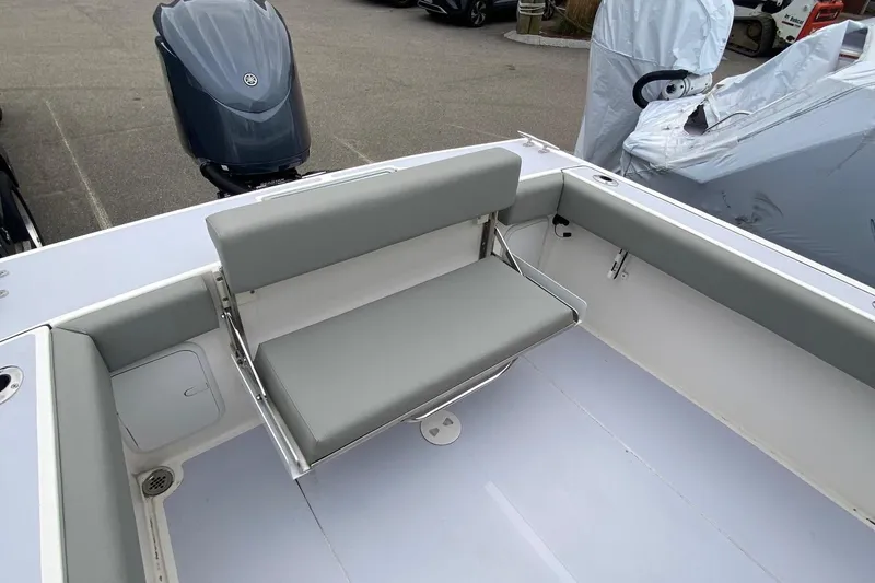 Slide: The Image of NorthCoast 235 HT 2025 boat with gray seating and outboard motor. - 10