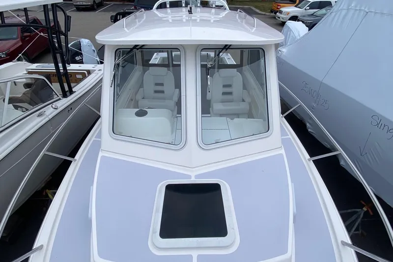 Slide: The Image of 2025 NorthCoast 235 HT boat with sleek design and spacious cabin. - 11