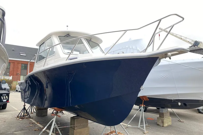 Slide: The Image of 2025 NorthCoast 235 HT boat with blue hull on display. - 2