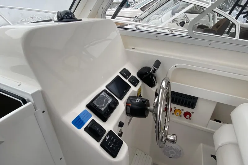 Slide: The Image of 2025 NorthCoast 235 HT boat helm with modern controls and steering wheel. - 20