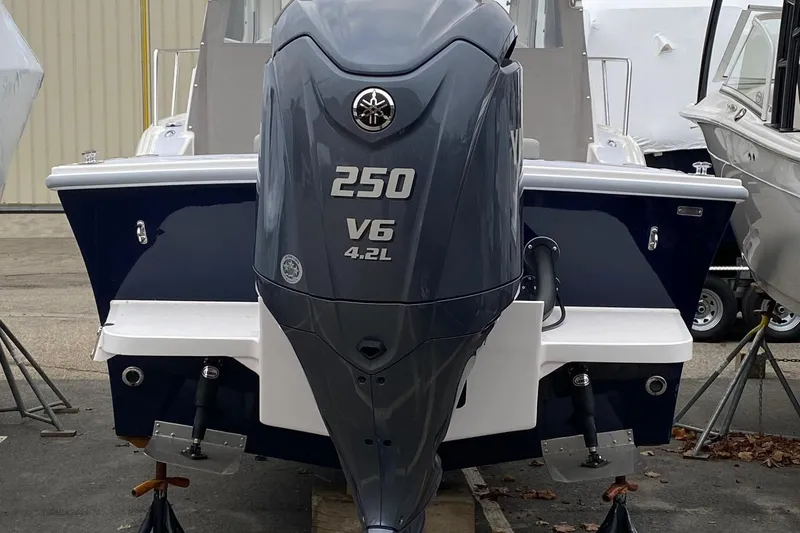 Slide: The Image of 2025 NorthCoast 235 HT boat with 250 V6 4.2L engine, rear view. - 3