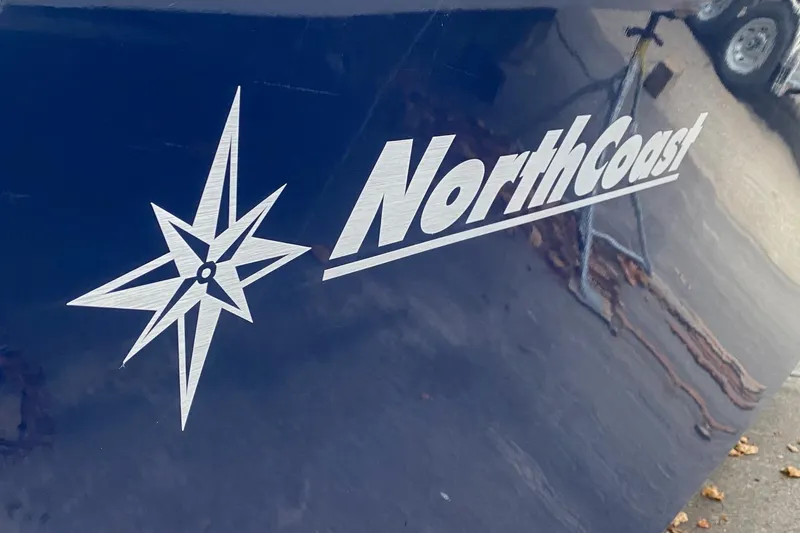 Slide: The Image of NorthCoast 235 HT 2025 boat logo on dark blue hull. - 5
