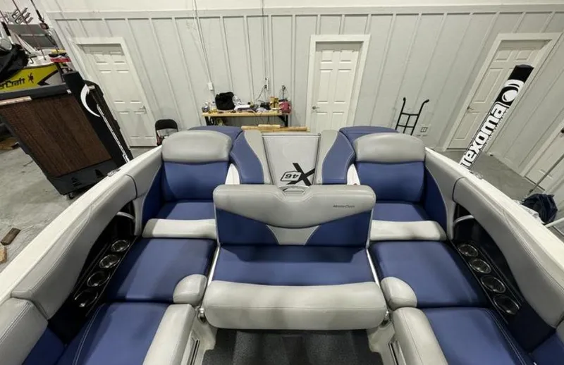Slide: The Image of 2016 MasterCraft X46 boat interior with blue and gray seating. - 11
