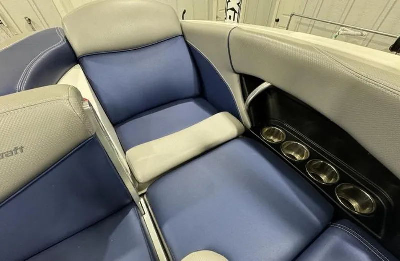 Slide: The Image of 2016 MasterCraft X46 boat interior with blue and gray seating and cup holders. - 13