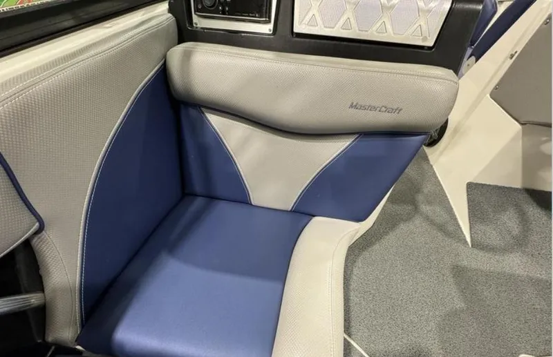 Slide: The Image of 2016 MasterCraft X46 boat interior with blue and gray seating. - 16