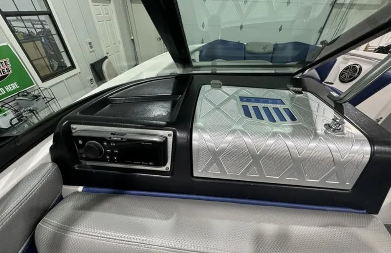 Slide: The Image of 2016 MasterCraft X46 dashboard with stereo and sleek silver panel design. - 17