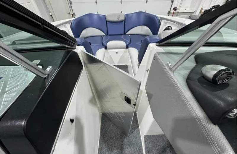 Slide: The Image of 2016 MasterCraft X46 boat interior with blue and gray seating. - 18