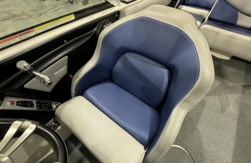Slide: The Image of 2016 MasterCraft X46 boat interior with blue and gray captain's seat. - 19