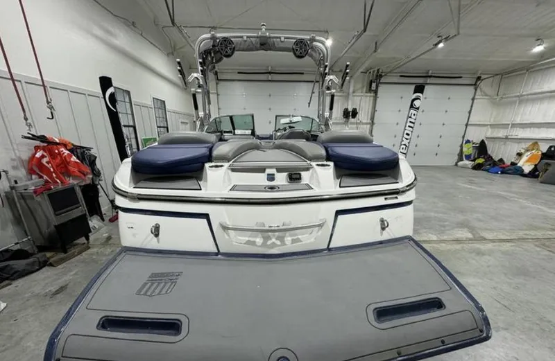Slide: The Image of 2016 MasterCraft X46 boat in a garage, rear view with swim platform. - 3
