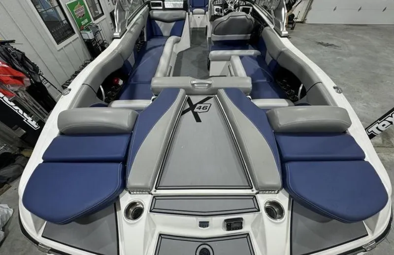 Slide: The Image of 2016 MasterCraft X46 boat interior with blue and gray seating, spacious layout. - 8