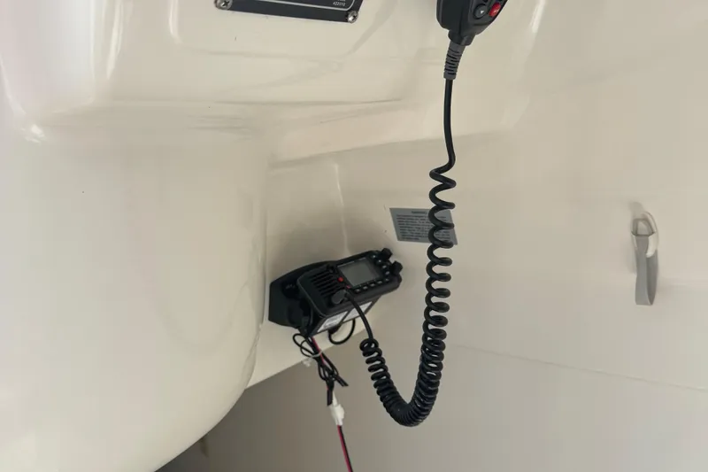 Slide: The Image of VHF radio installed on a 2002 MacGregor 26X boat interior. - 14