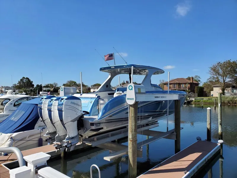 Slide: The Image of 2018 Mystic Powerboats M4200 docked with triple outboard engines. - 31