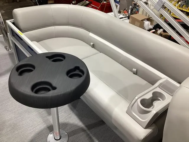 Slide: The Image of 2025 Godfrey Xperience 2286 SBX boat interior with gray seating and cup holders. - 11