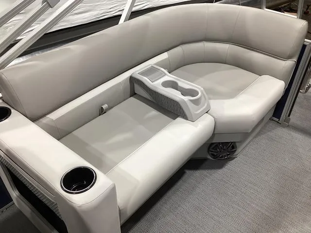 Slide: The Image of 2025 Godfrey Xperience 2286 SBX boat interior with plush seating and cup holders. - 12
