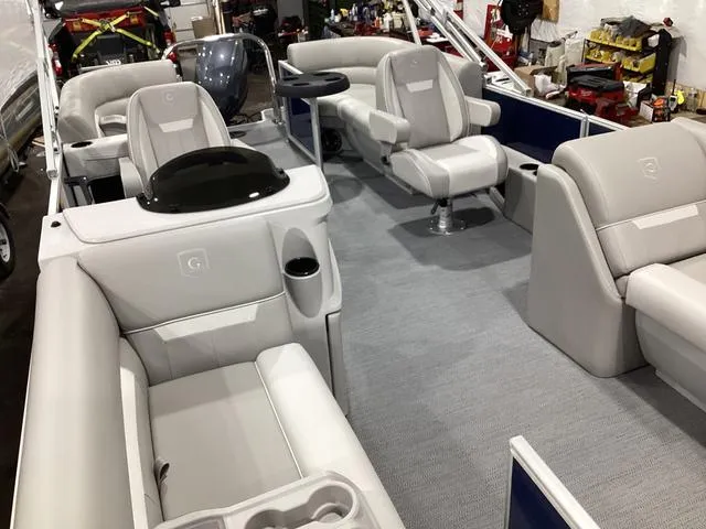 Slide: The Image of 2025 Godfrey Xperience 2286 SBX pontoon boat interior with plush seating and modern design. - 18