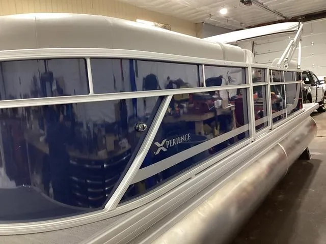 Slide: The Image of 2025 Godfrey Xperience 2286 SBX pontoon boat in a garage setting. - 20