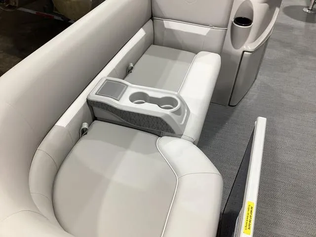Slide: The Image of 2025 Godfrey Xperience 2286 SBX boat interior with plush seating and cup holders. - 3