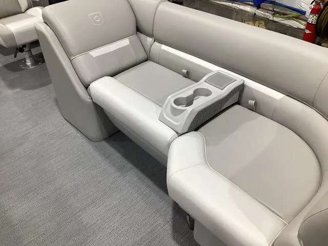 Slide: The Image of 2025 Godfrey Xperience 2286 SBX boat interior with gray seating and cup holders. - 4