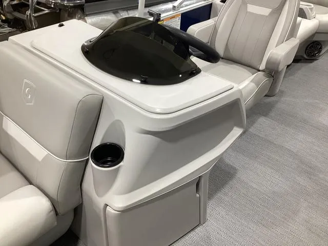 Slide: The Image of 2025 Godfrey Xperience 2286 SBX boat interior with sleek helm and comfortable seating. - 5