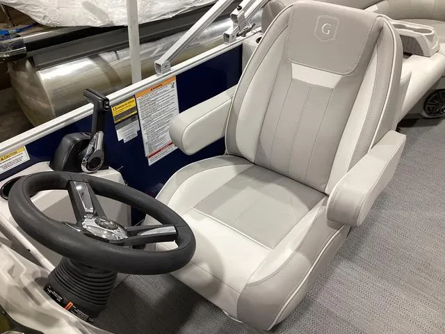 Slide: The Image of Captain's seat of 2025 Godfrey Xperience 2286 SBX pontoon boat, featuring sleek design and controls. - 7
