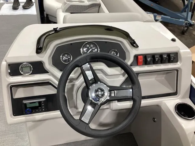 Slide: The Image of 2025 Godfrey Xperience 2286 SBX boat dashboard with steering wheel and control panel. - 8