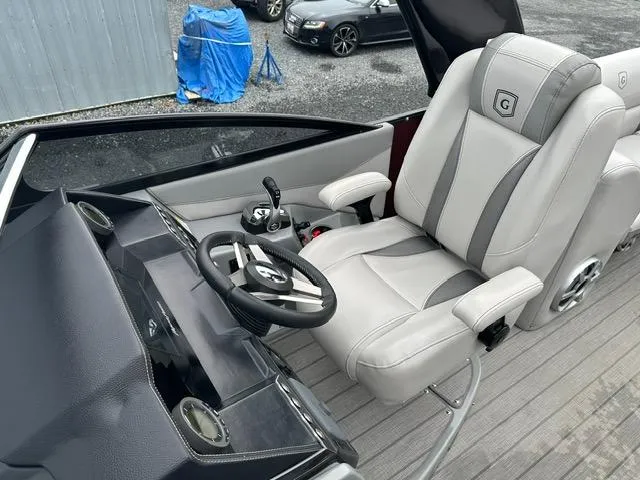 Slide: The Image of Captain's seat of 2018 Godfrey Aqua Patio 259ULW Tri-Toon boat, featuring sleek design. - 6