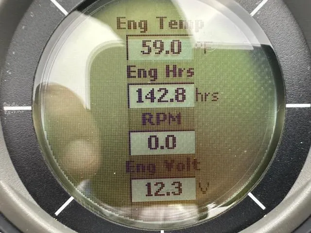 Slide: The Image of Close-up of 2018 Godfrey Aqua Patio 259ULW Tri-Toon engine display showing temperature, hours, RPM, and voltage. - 7
