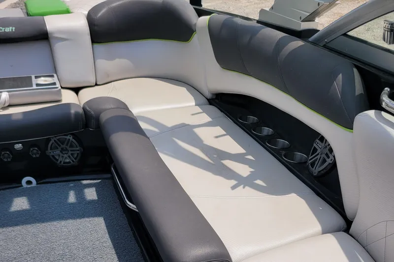 Slide: The Image of 2012 MasterCraft X25 boat interior with cushioned seating and cup holders. - 17
