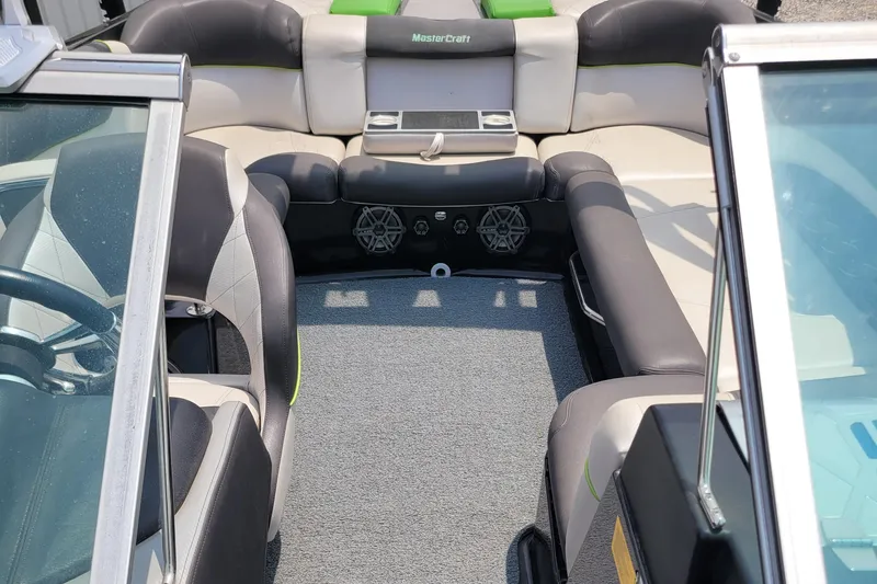 Slide: The Image of 2012 MasterCraft X25 boat interior with gray and black seating, featuring a modern design. - 18