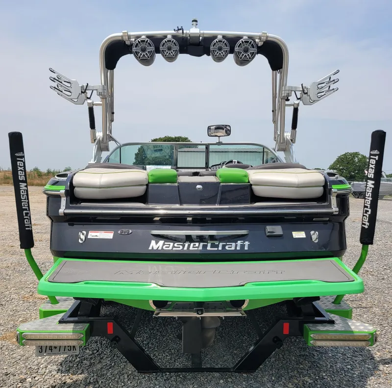 Slide: The Image of 2012 MasterCraft X25 boat with green accents and wakeboard tower. - 6