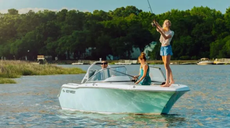Slide: The Image of 2025 Key West 203DFS boat on a lake with people fishing. - 1