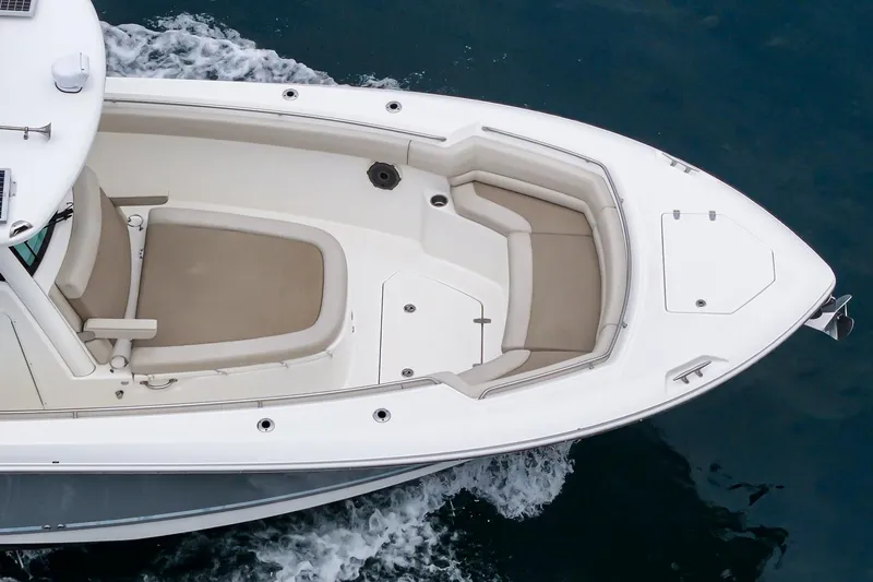 Slide: The Image of 2019 Boston Whaler 330 Outrage boat, aerial view, cruising on water. - 11